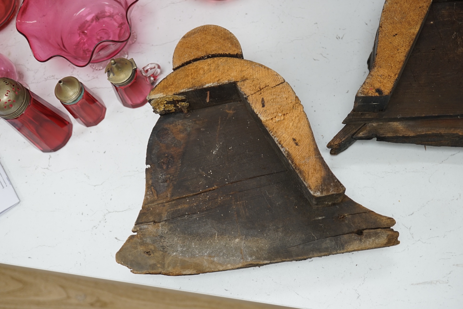 Two 17th/18th century ‘Golden Fleece architectural pine signs with partially gilt decoration, by repute the Golden fleece device was used on a hardware store in Horninglow Street, Burton on Trent 27cm high. Condition - f